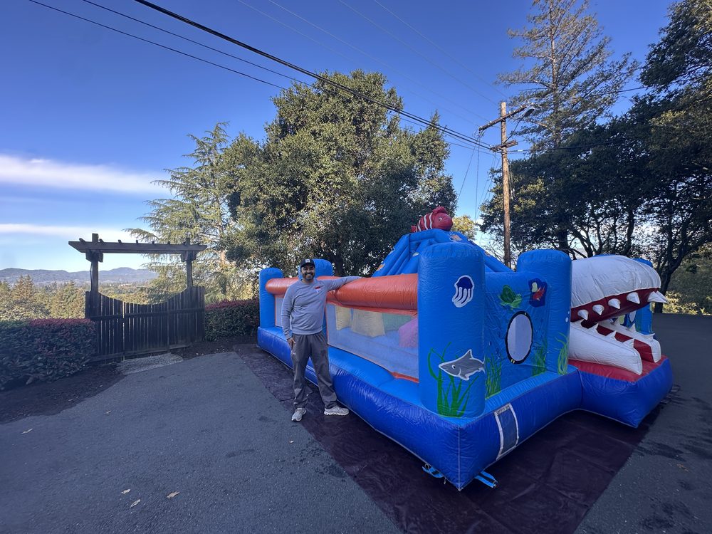 A Napa Valley Jumpers owner standing beside the ocean combo at a delivery